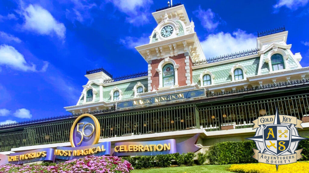 Walt Disney World Magic Kingdom Train Station with 50th Anniversary Celebration decorations, in lower right corner is The Gold Key Adventurers Society logo