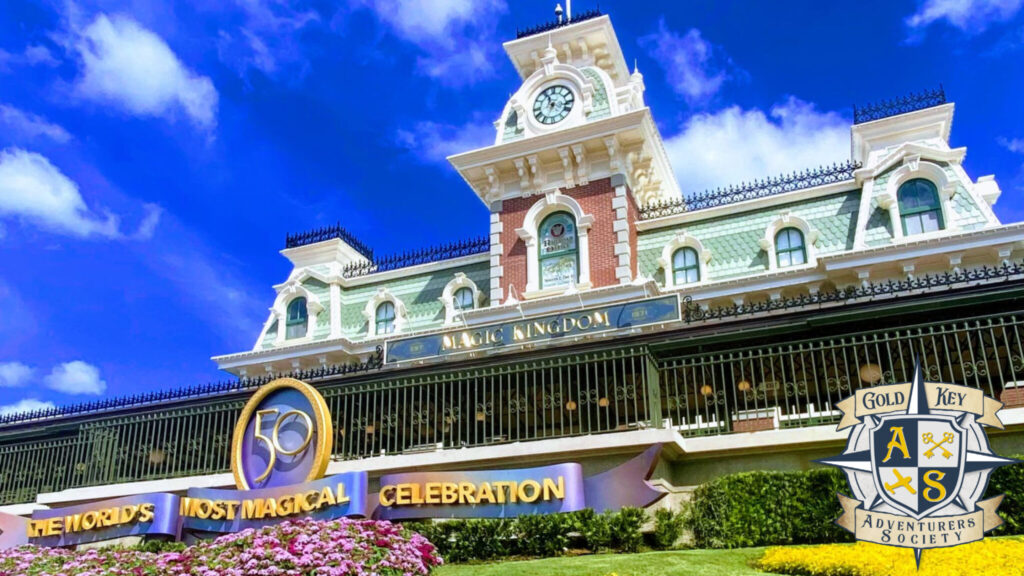 Walt Disney World Magic Kingdom Train Station with 50th Anniversary Celebration decorations, in lower right corner is The Gold Key Adventurers Society logo