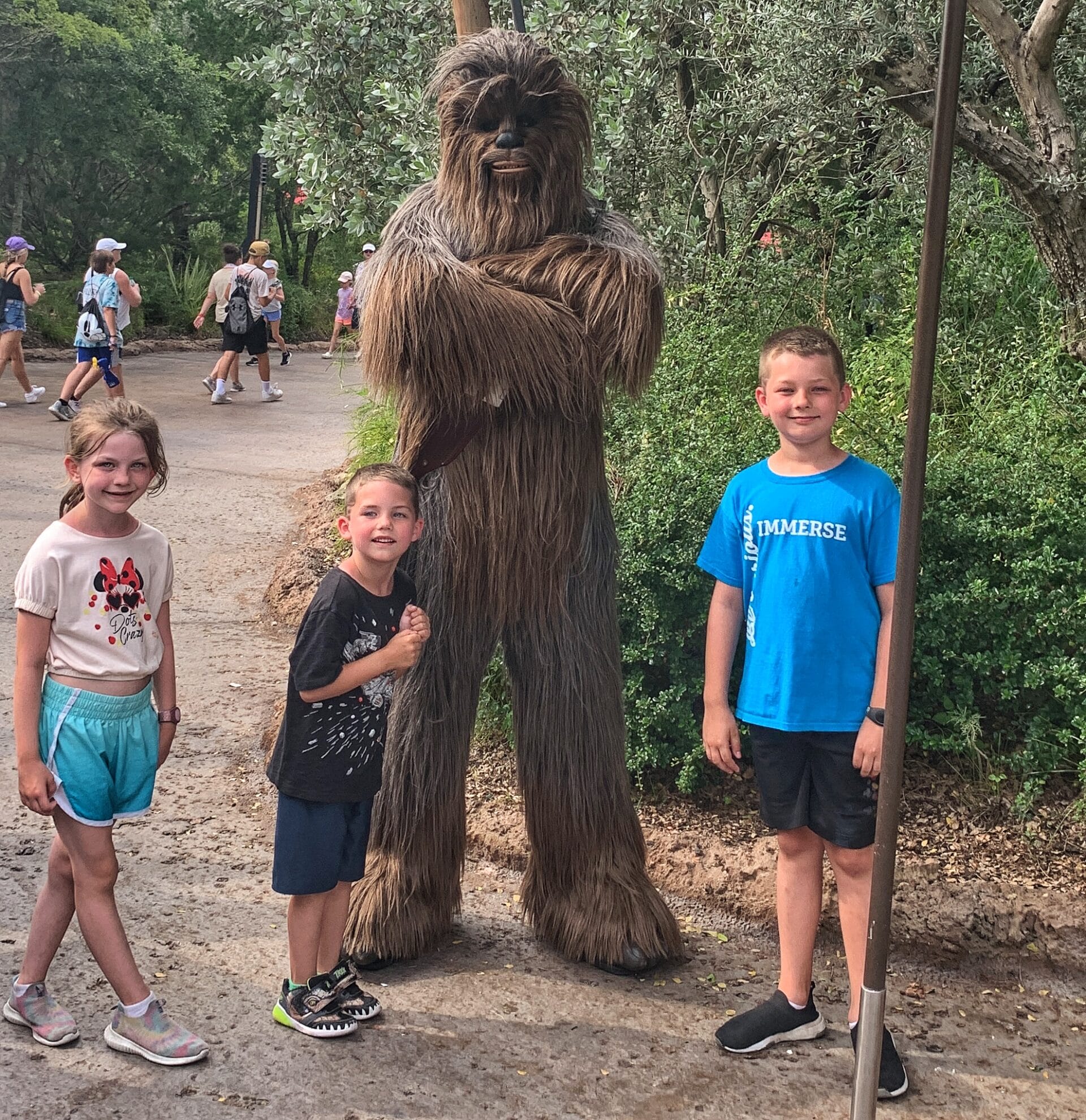 3 kids with Chewbacca at Star Wars: Galaxy's Edge in Disney's Hollywood Studios