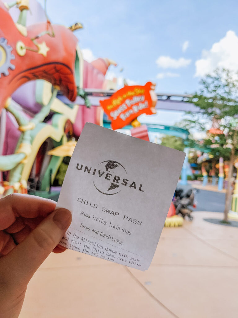 Child Swap Pass held in front of Seuss Trolley Train Ride
