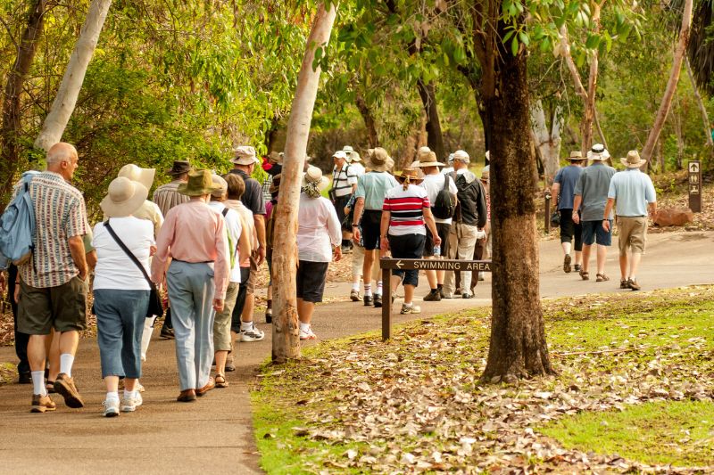 Large group of seniors walking along a path