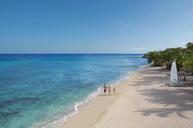 Couple walking along the beach in one of the best Mexico vacation spots