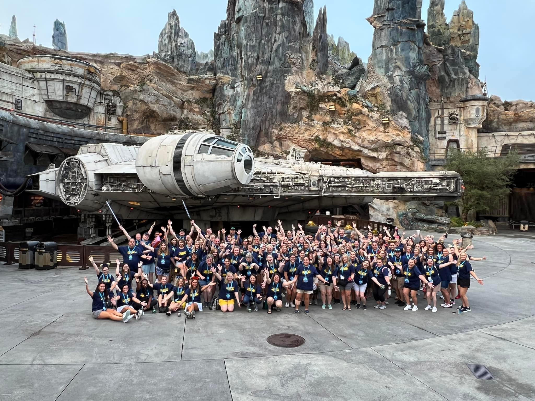 travel advisors for Key to the World Travel posed in front of the Millennium Falcon at Walt Disney World